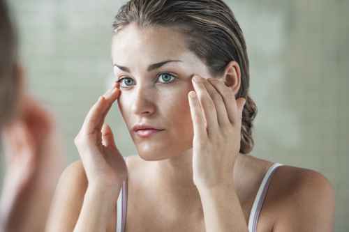 Woman Applying Facial Cream